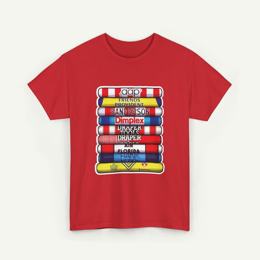 A red t-shirt with a graphic design depicting a stack of colorful books or book-like objects, each with a different title or name printed on them.