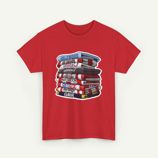 A red t-shirt with a graphic design depicting a stack of books with various titles written on them.