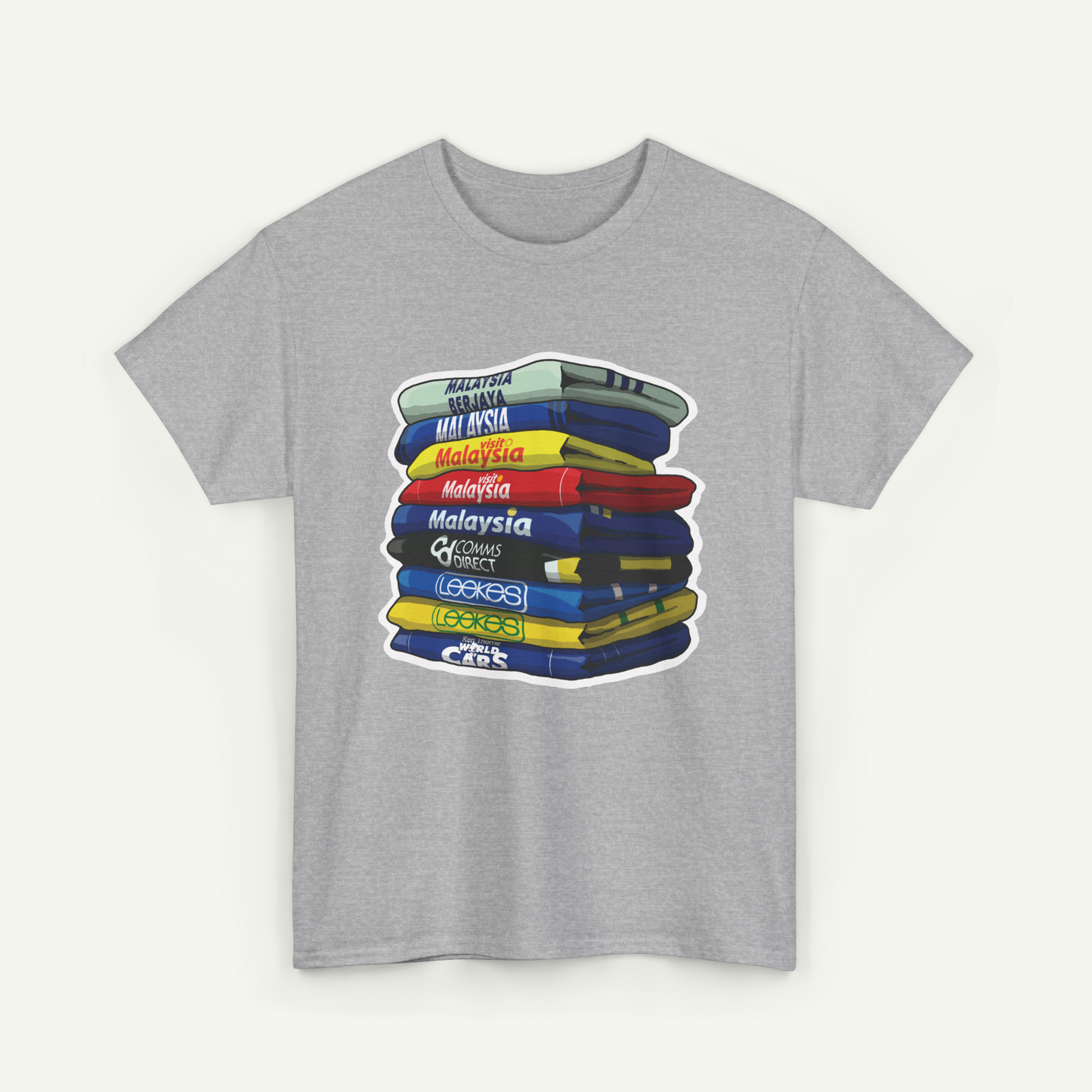 A gray t-shirt with a graphic design depicting a stack of books or books, with each book having a different color and title.