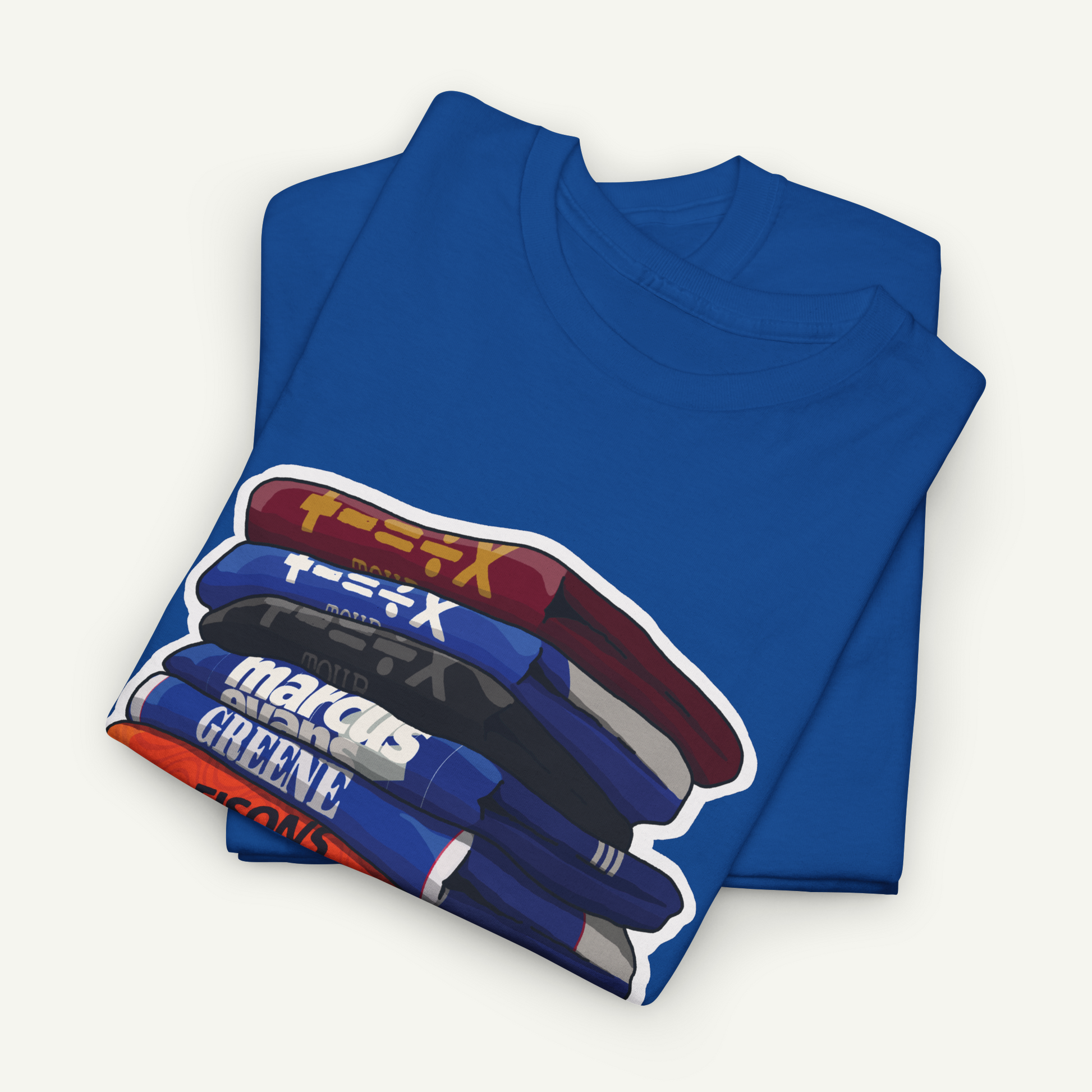 A blue t-shirt with a graphic design depicting a stack of books or magazines.