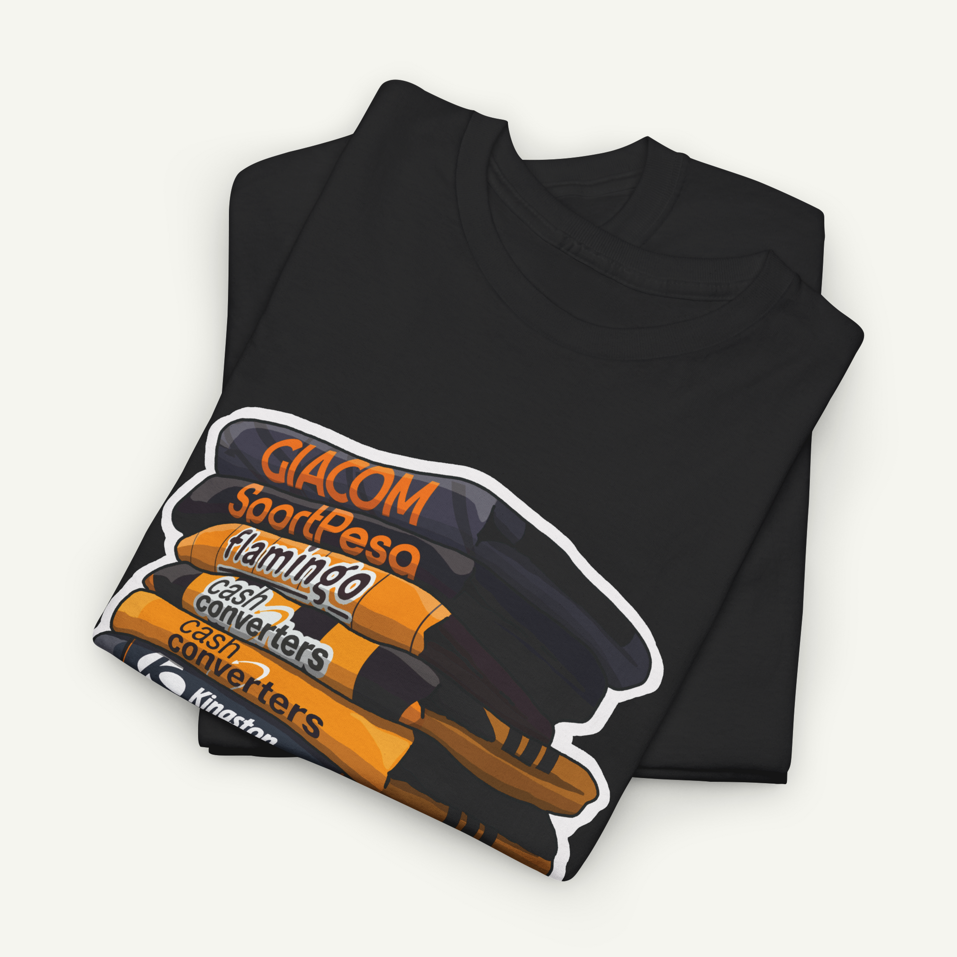 A black t-shirt with a graphic design depicting a stack of various objects, including a flamingo, cash converters, and a keyboard.