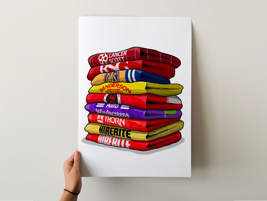 A hand is holding a poster with a stack of colorful towels, each with a different brand name printed on it.