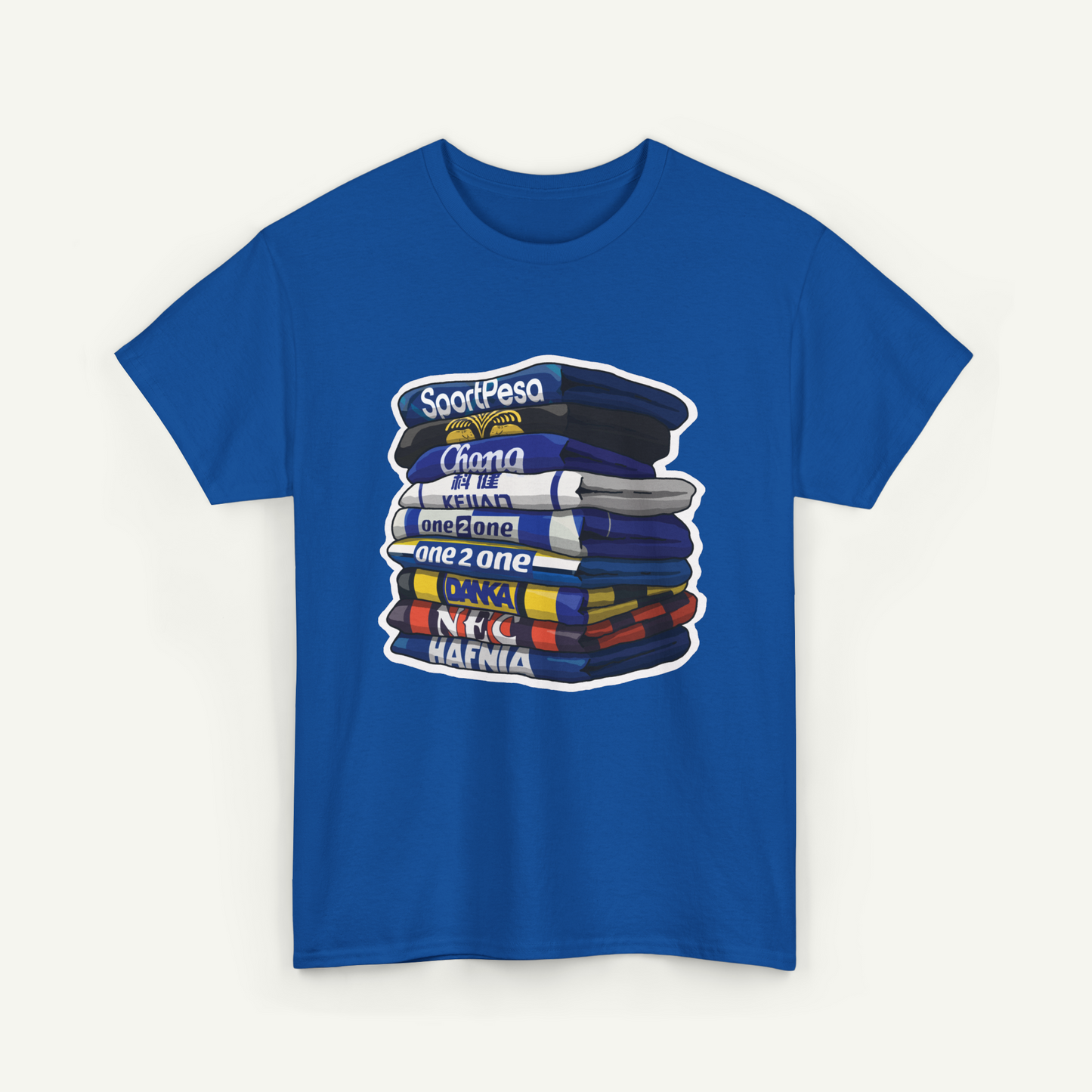 A blue t-shirt with a graphic design depicting a stack of books or magazines with various titles written on them.