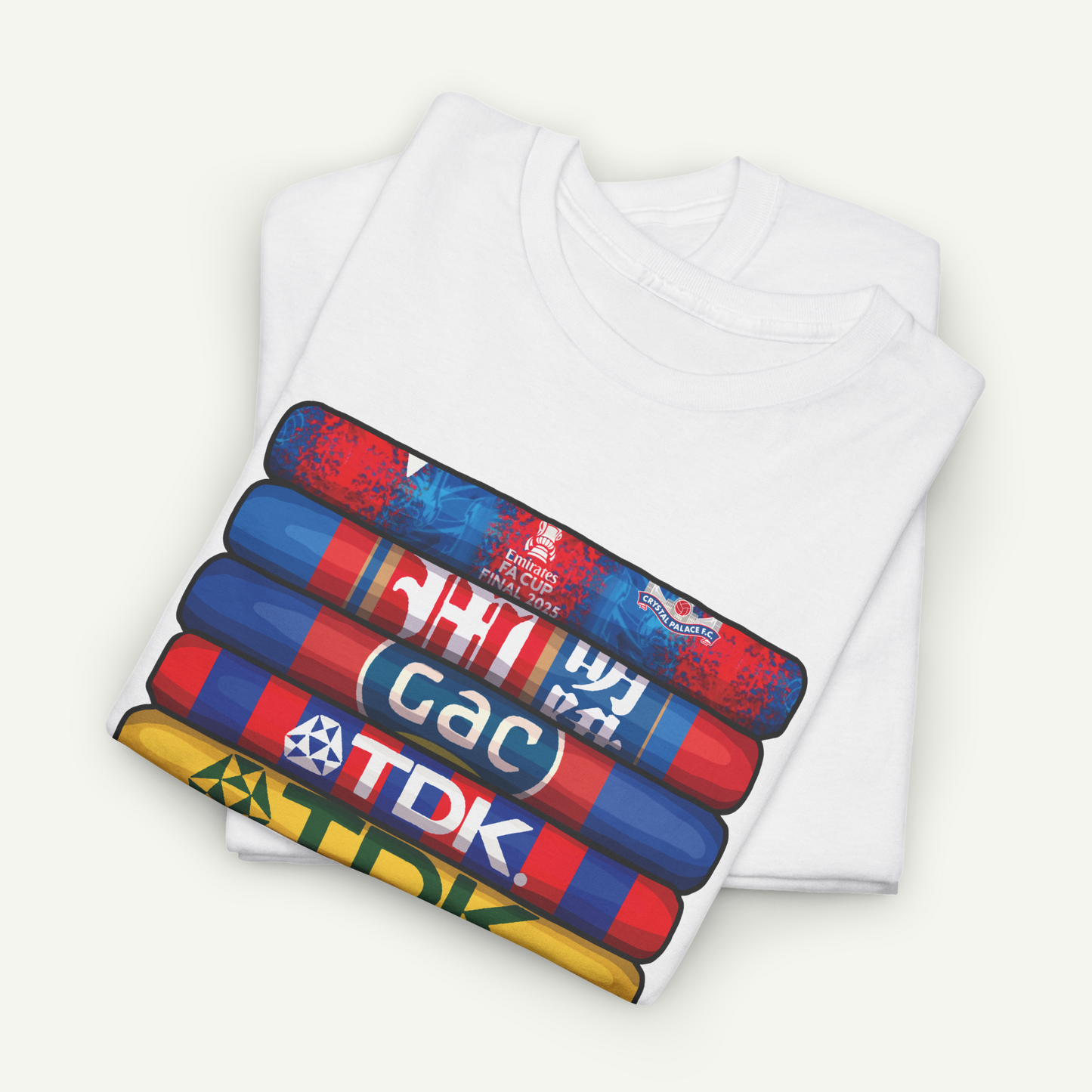 A white t-shirt with a graphic design featuring a stack of colorful tubes or cylinders with various text and logos printed on them.