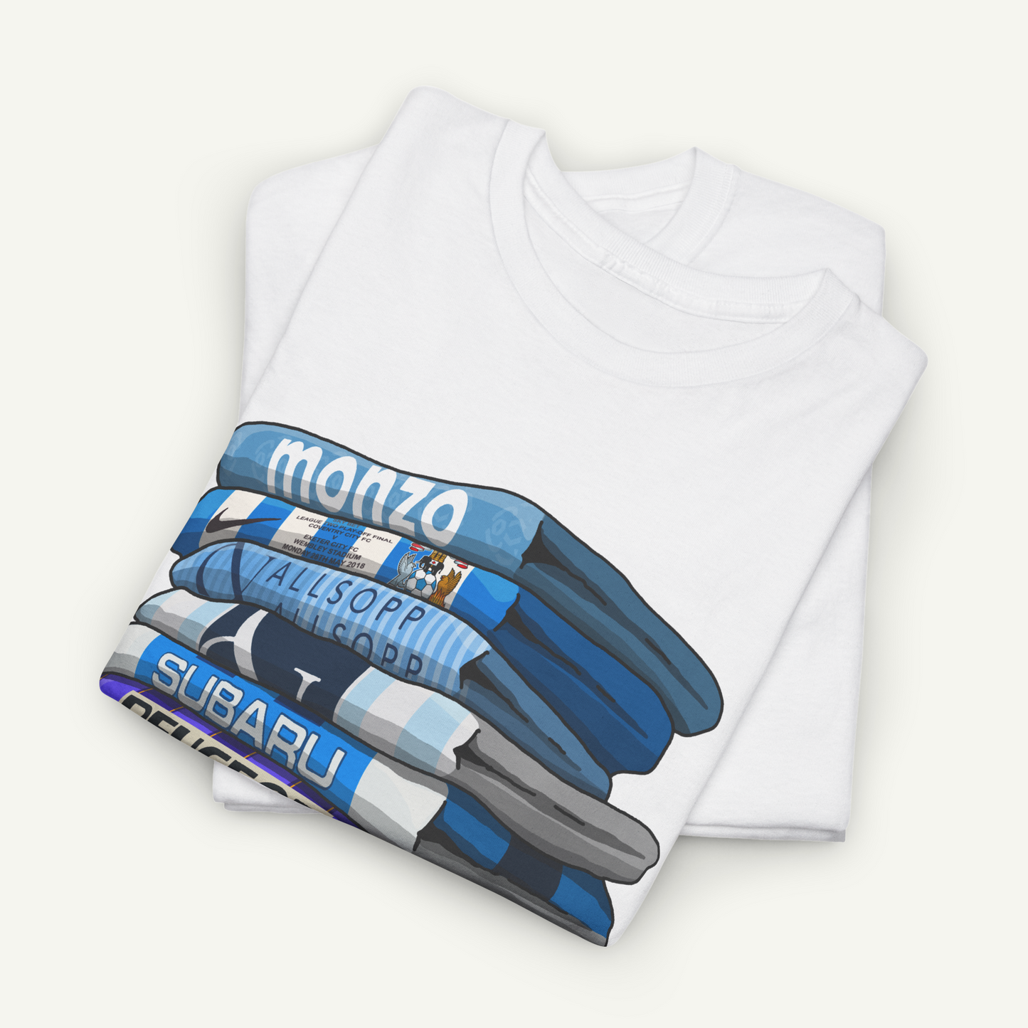 A white t-shirt with a graphic design depicting a stack of blue and white striped shirts, with the text "MONZA" and "SUBARU" printed on them.