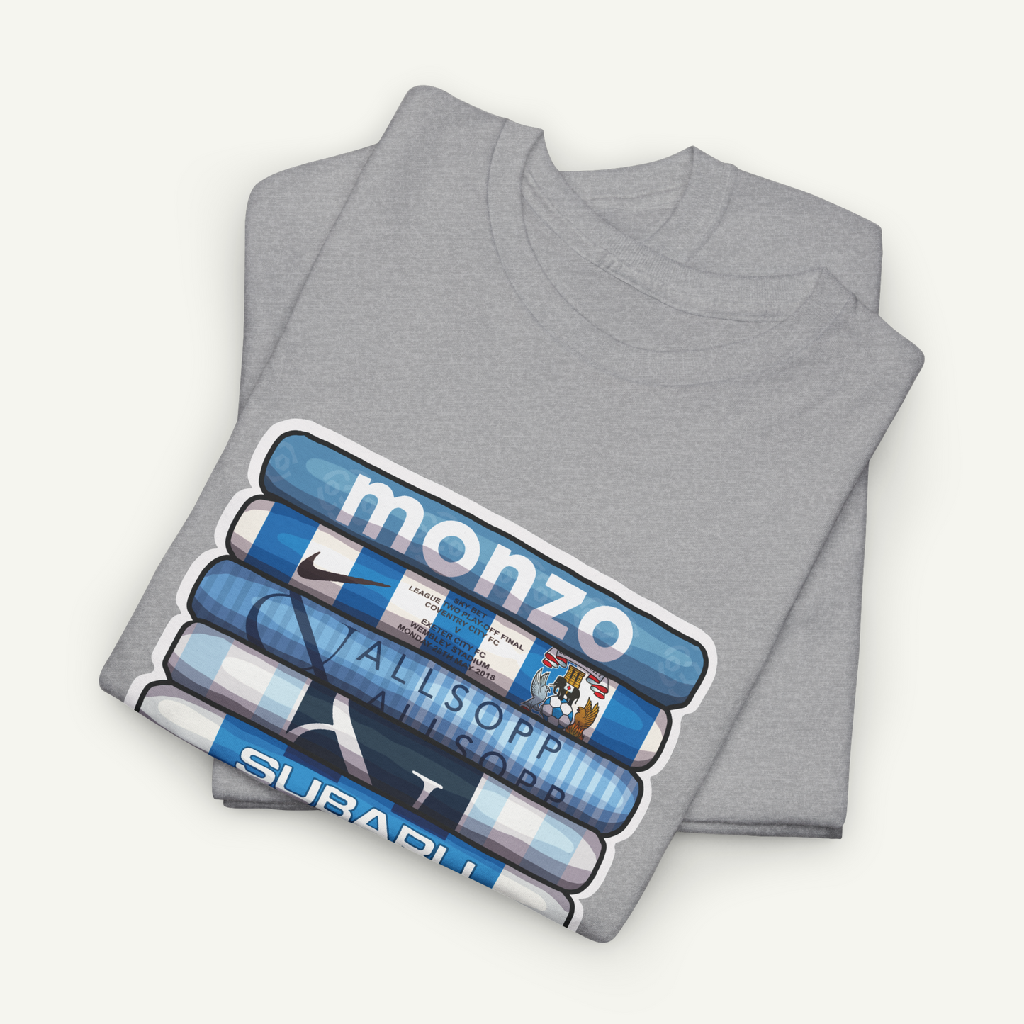 A gray t-shirt with a graphic design featuring a stack of blue and white tubes with the word "MONZO" printed on them.