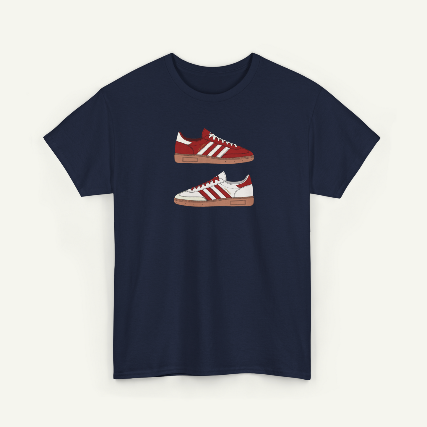 A navy blue t-shirt with a graphic design of two red and white Adidas sneakers printed on it.