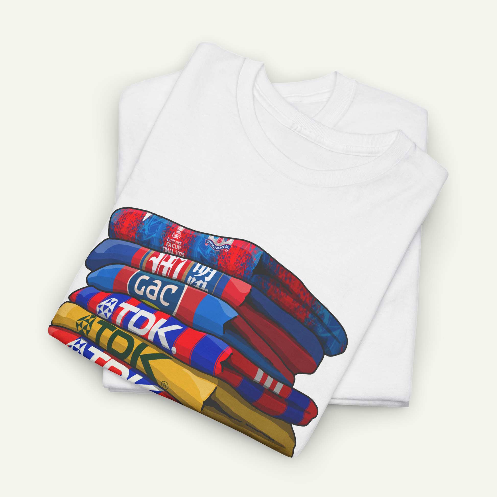 A white t-shirt with a colorful graphic design depicting a stack of various colored shirts.