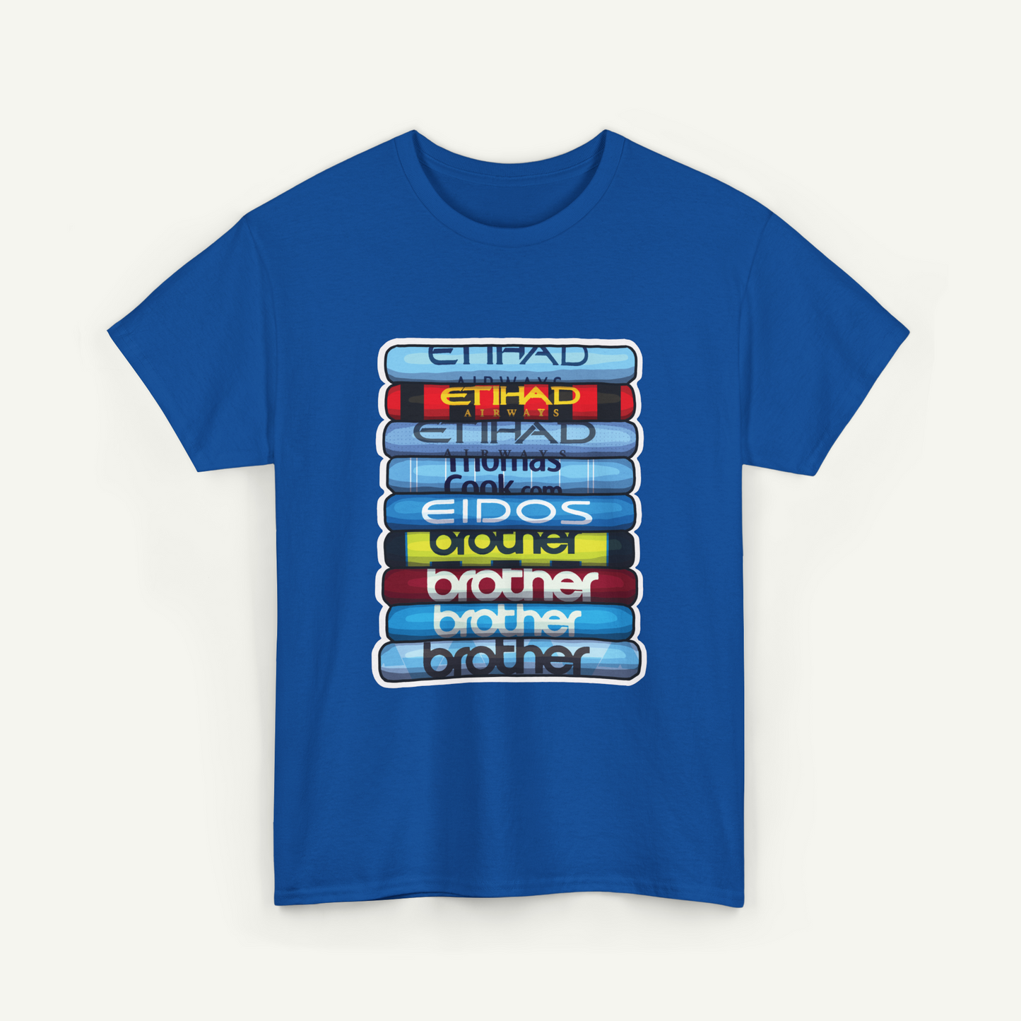 A blue t-shirt with a graphic design depicting a stack of books with the titles "Etihad" and "Thomas" written on them.
