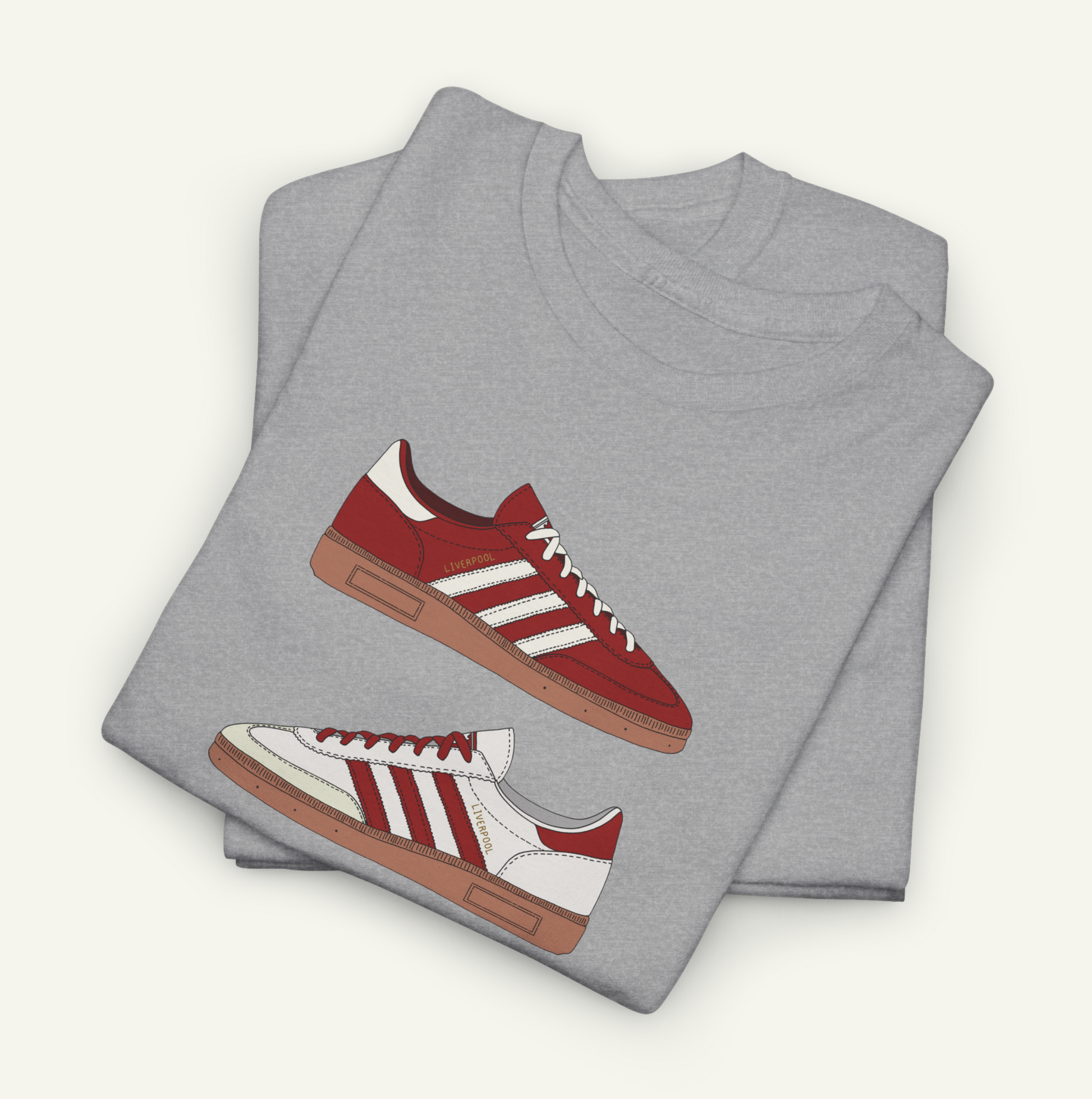 A gray t-shirt with a graphic design of a red and white Adidas sneaker printed on it.