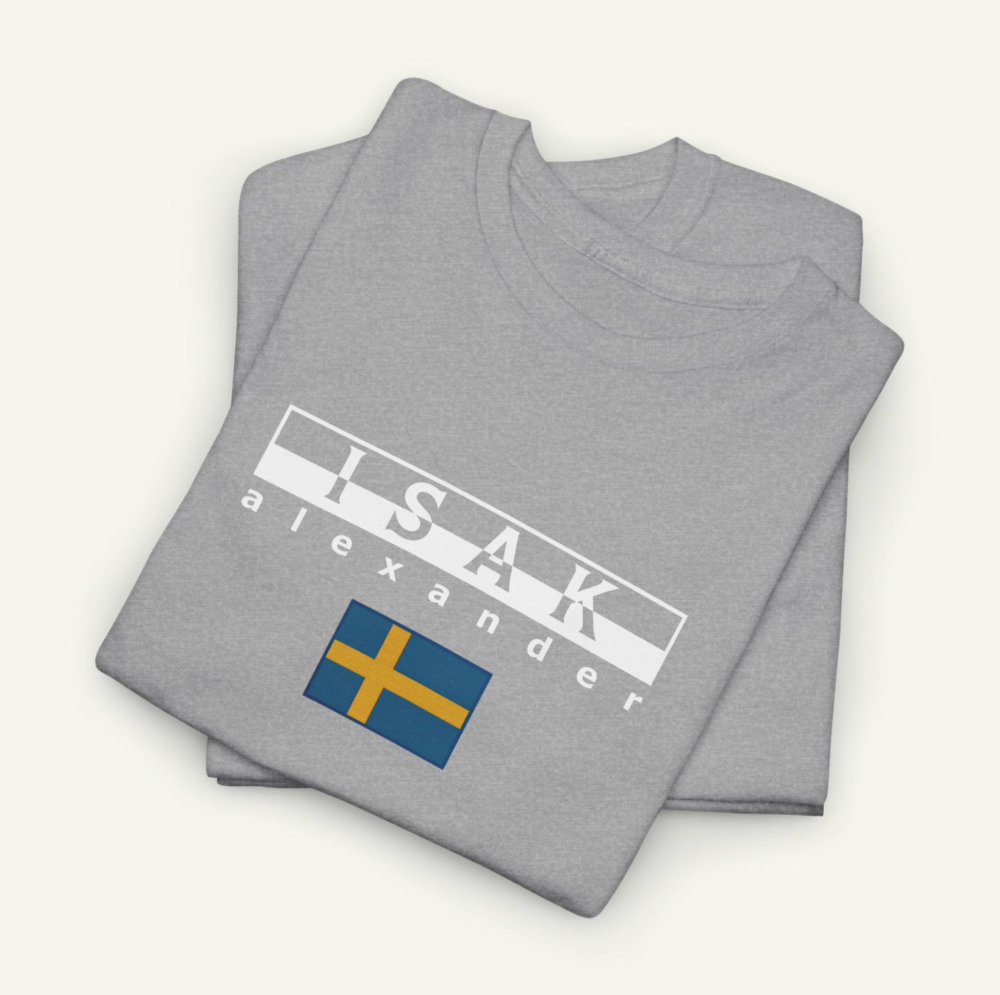 a gray t-shirt with the text "ISAK Alexander" printed on it, along with a small flag design.