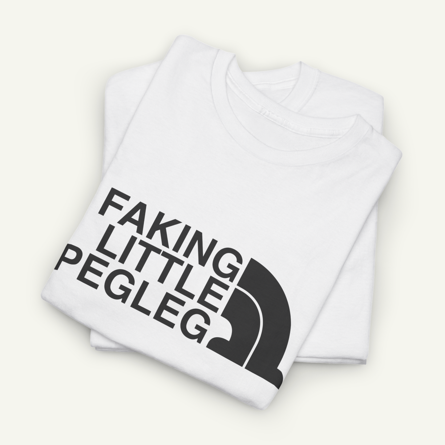 A white t-shirt with the text "FAKING LITTLE PEGLEG" printed on it.