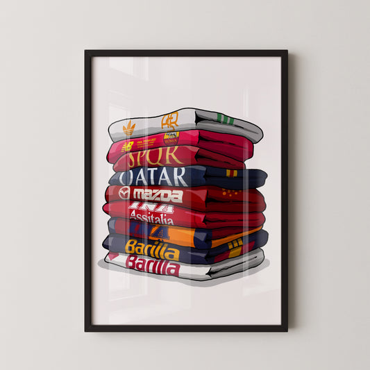 A framed illustration depicting a stack of colorful towels with various logos and text, including "Qatar", "Spur", "Mazda", "Barilla", and "Assistal".