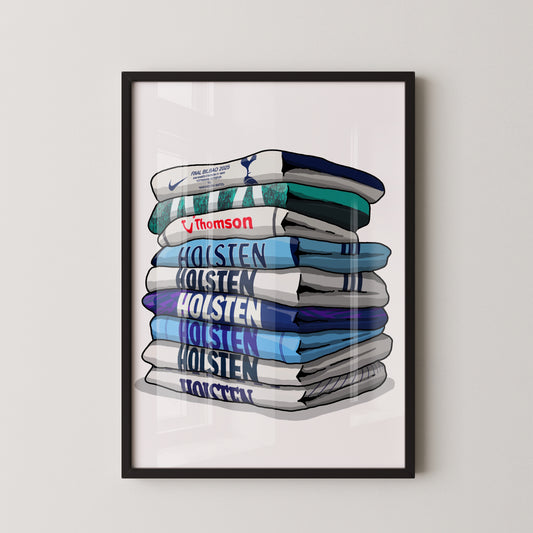 A framed illustration of a stack of various colored towels or blankets, with the text "Holsten Holsten Holsten" visible on the towels.