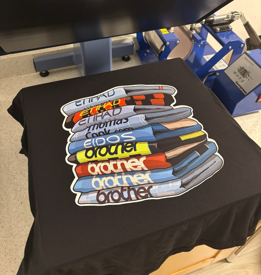 a t - shirt with a stack of books on it