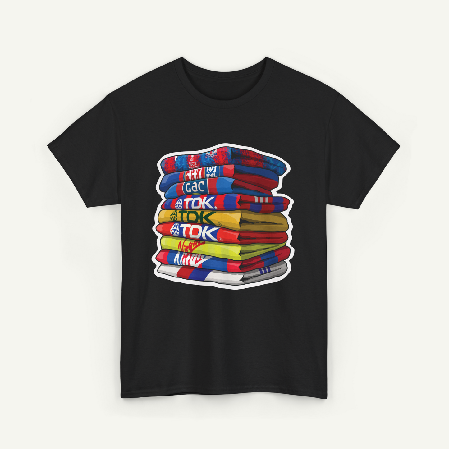 A black t-shirt with a colorful graphic design depicting a stack of books or books.