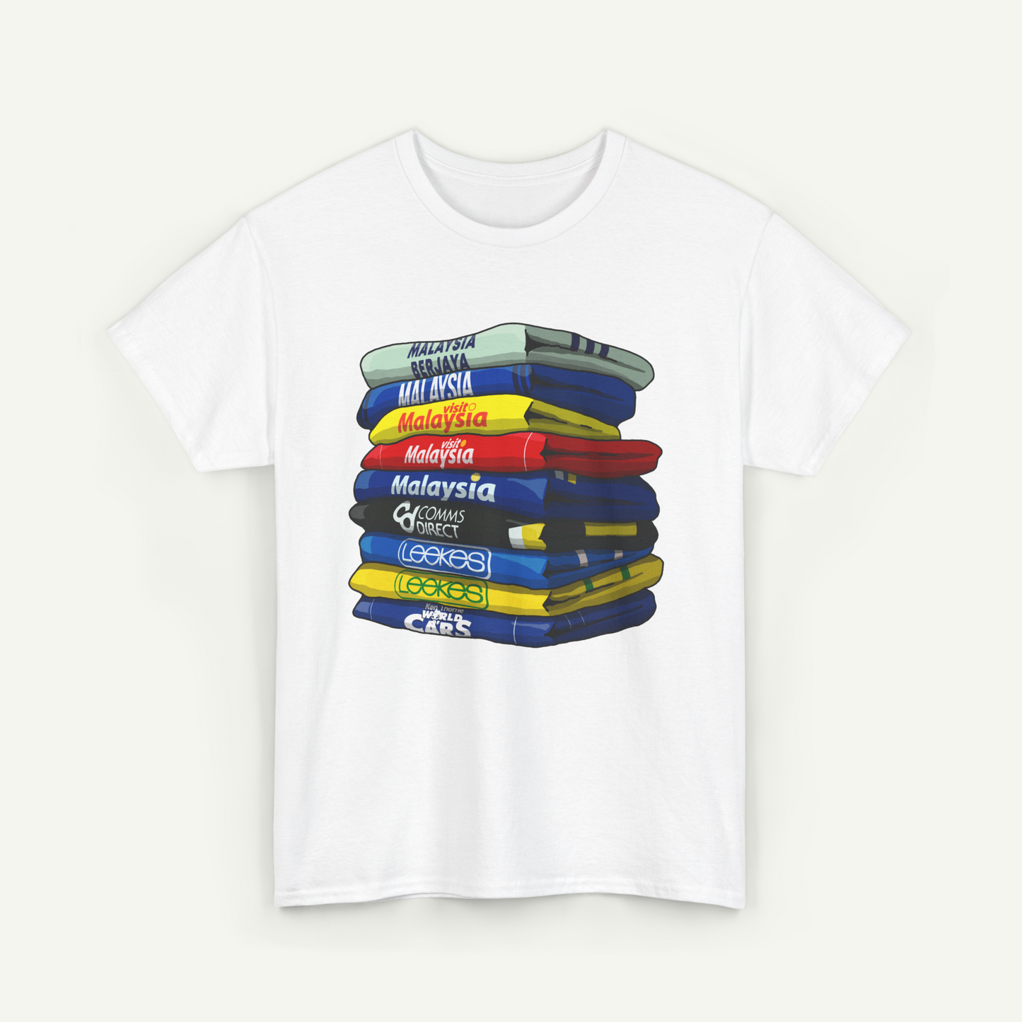 A white t-shirt with a graphic design depicting a stack of colorful books or magazines with various titles written on them.