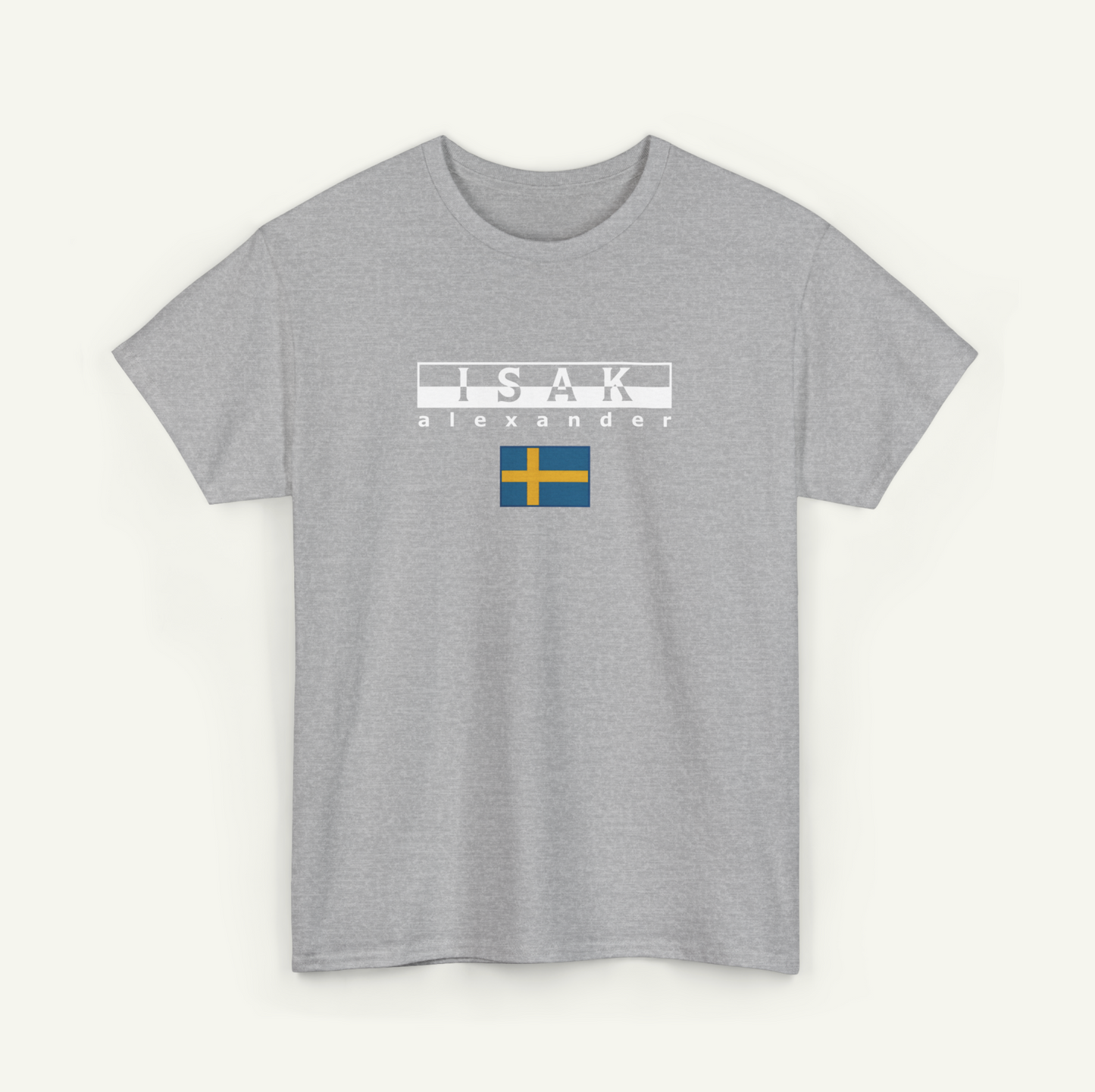A gray t-shirt with the text "ISAAK ALEXANDER" printed on it, along with a small flag design.