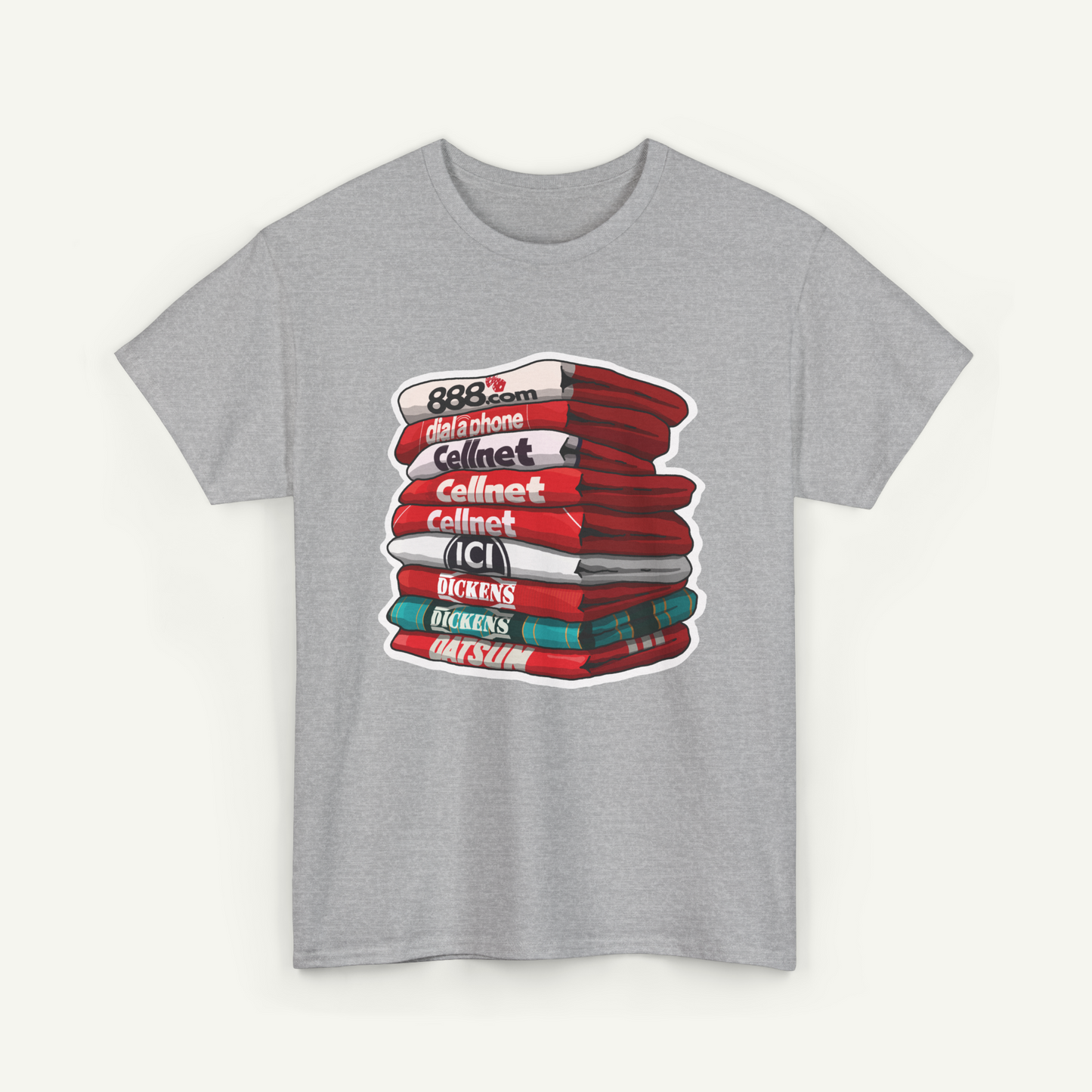 A gray t-shirt with a graphic design depicting a stack of books or magazines with various titles and text.
