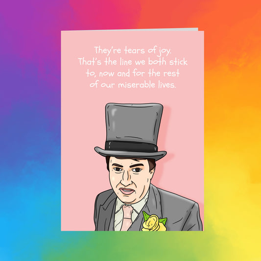 a man wearing a top hat and a suit, with a flower pinned to his lapel.