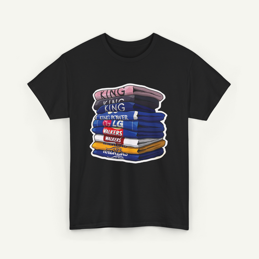 A black t-shirt with a graphic design depicting a stack of colorful books or books with the text "KING KING" written on them.