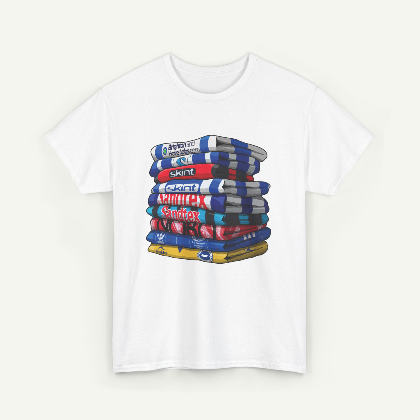 A white t-shirt with a graphic design depicting a stack of colorful books or magazines.