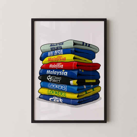 A framed illustration of a stack of colorful jerseys, each with a different country's name written on it.