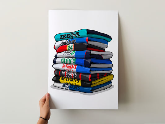 A hand is holding a poster with a stack of colorful shirts, each with a different text label.