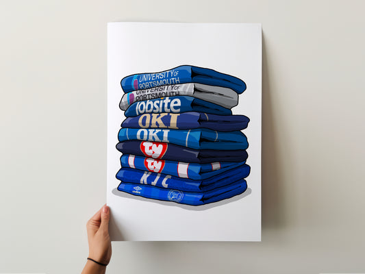 A hand is holding a poster with a stack of blue and white shirts, each with a different logo or text on them.