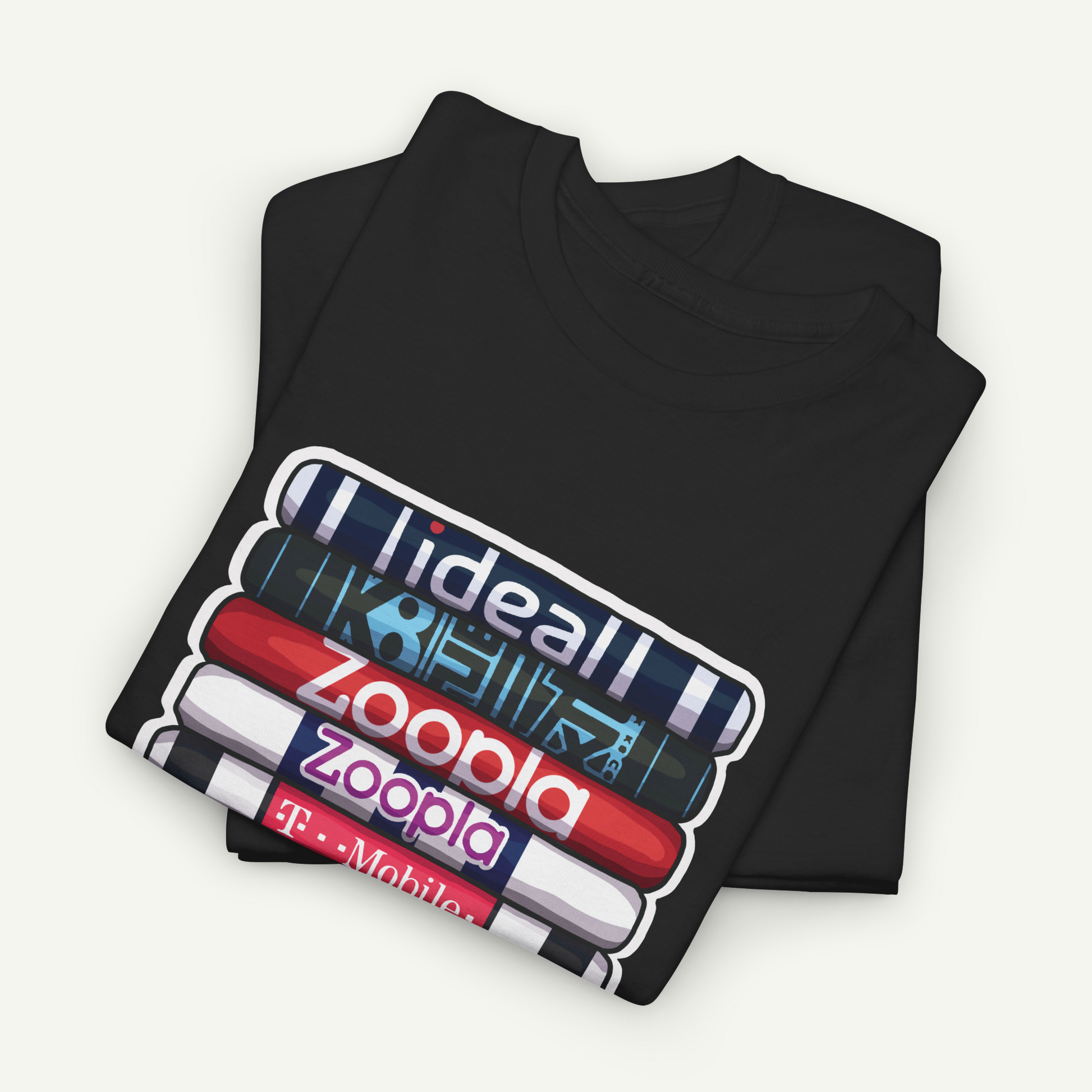 A black t-shirt with a graphic design featuring a stack of colorful books or magazines with the text "ideall" and "zoopla" printed on them.