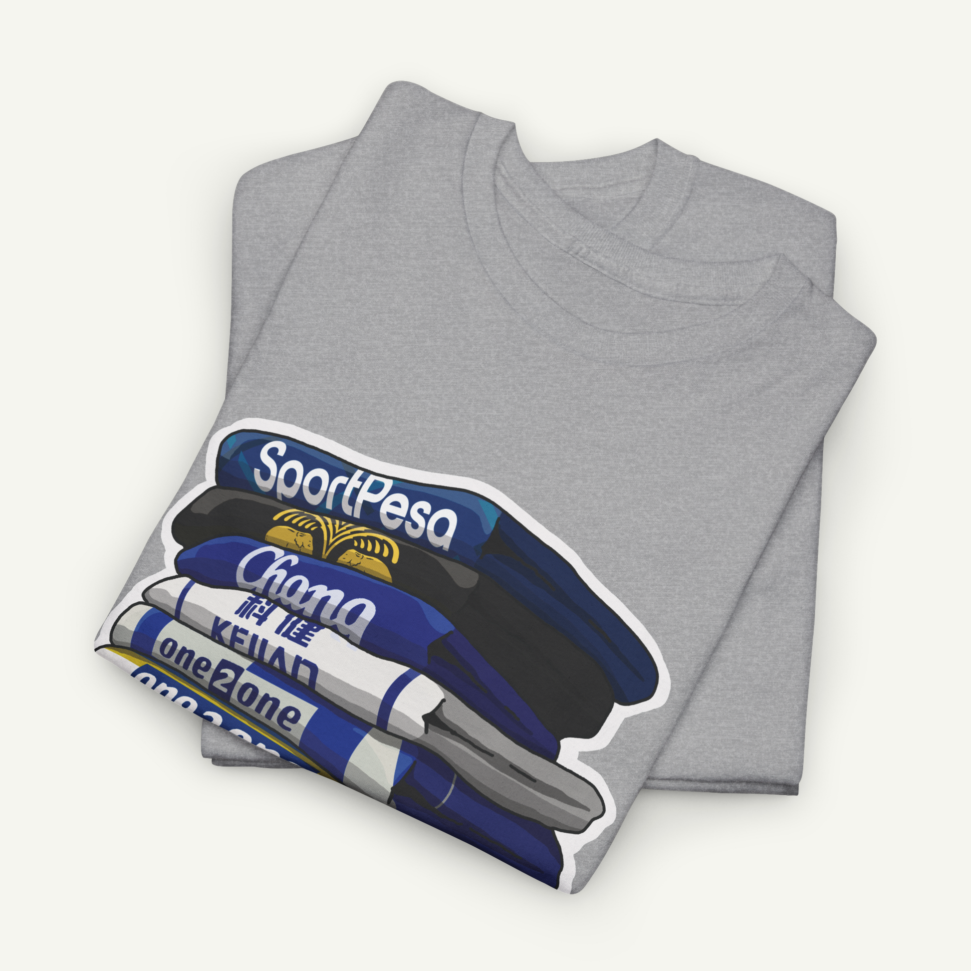 A gray t-shirt with a graphic design depicting a stack of books or magazines with the text "SportPesa" and "Chana" printed on them.