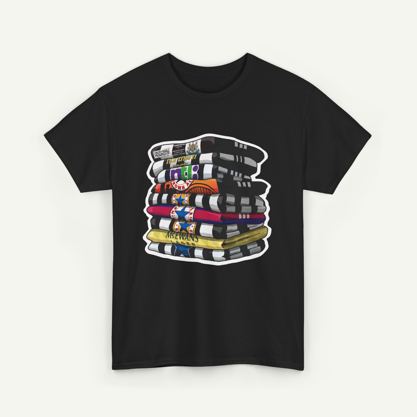 A black t-shirt with a graphic design depicting a stack of colorful books or magazines.