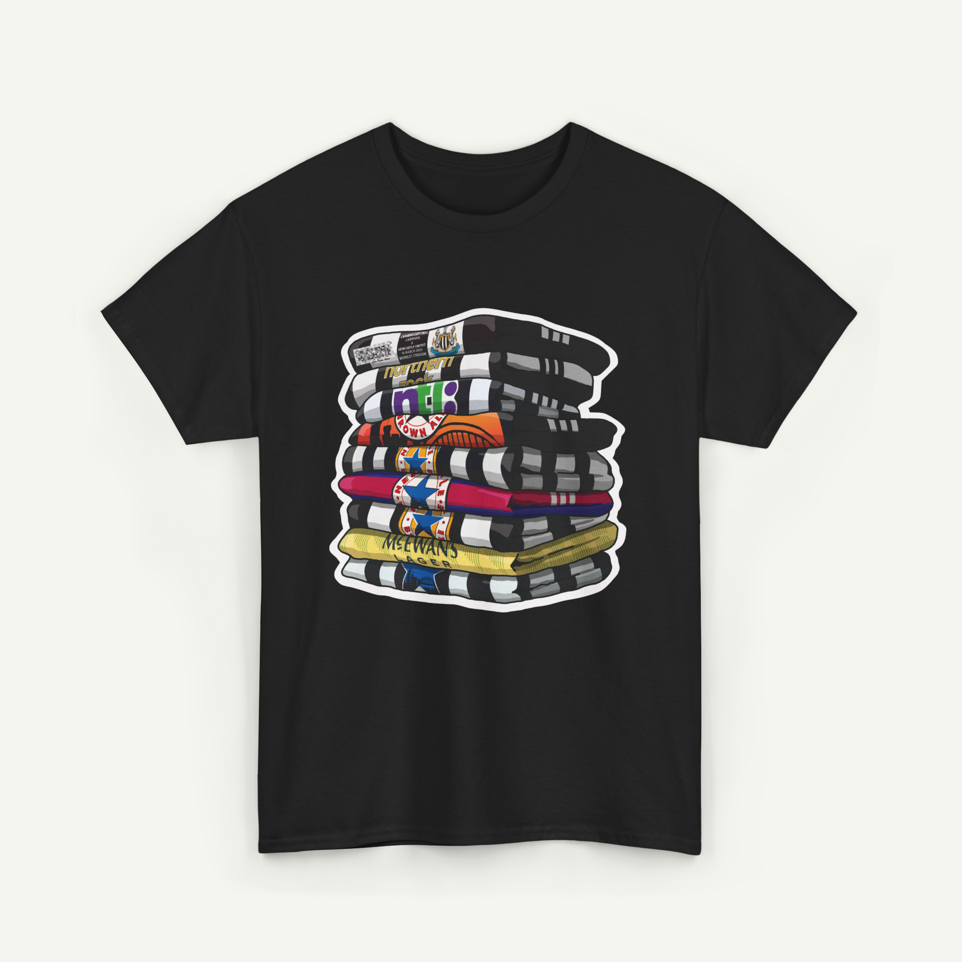 A black t-shirt with a graphic design depicting a stack of colorful books or magazines.